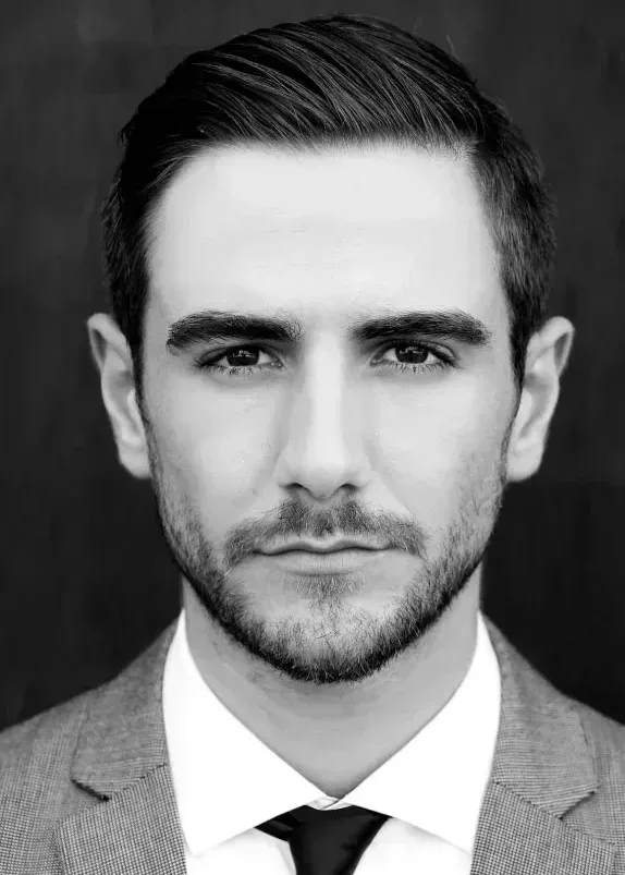 A black and white photo of a man in a suit.